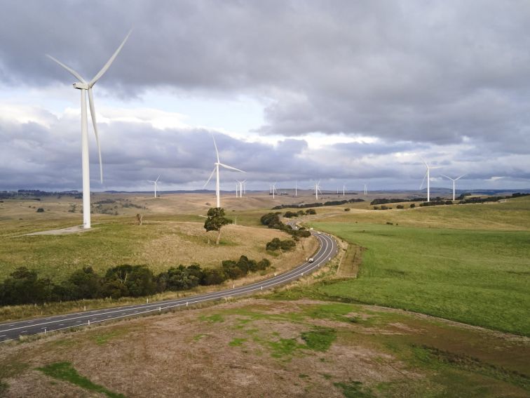landscape shot of wind farm with numerous turbines off in distance