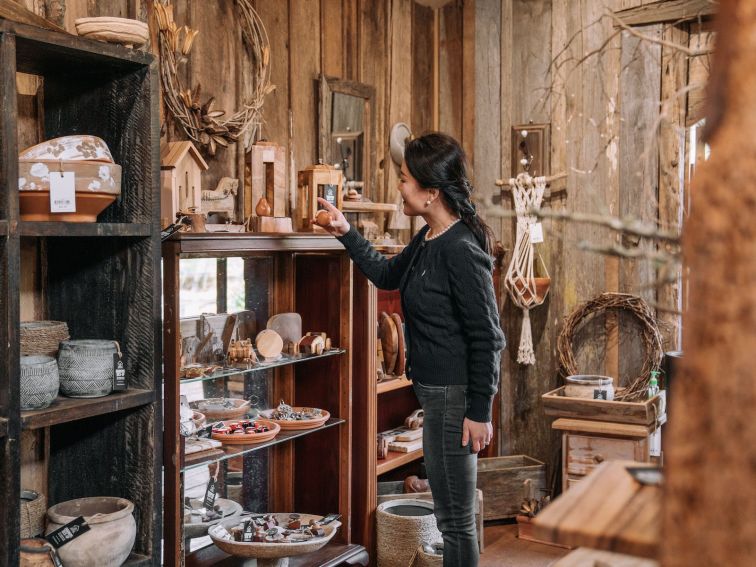 A female customer browses handcrafted items at a giftshop
