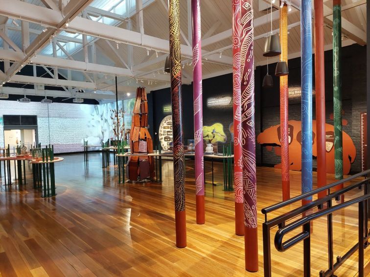 Photo shows poles evoking Aboriginal  Peoples message sticks and the interior of the Museum