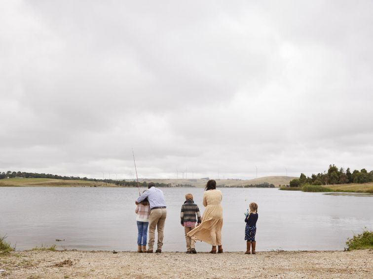Family of four people standing on he edge of Pejar Dam