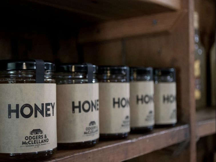 Local honey on original packing case shelving.