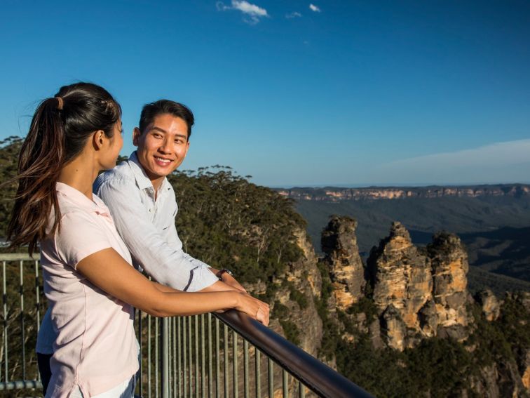 Couple enjoying views of the Three Sisters and across the Jamison Valley from Echo Point Lookout