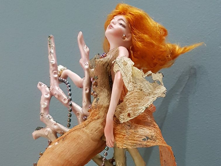 A porcelain redheaded mermaid