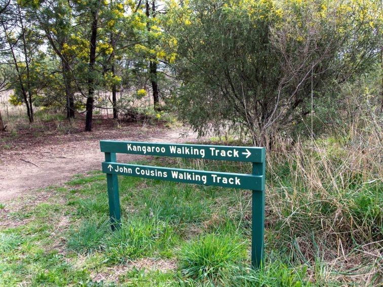 a signpost for the John Cousins Walking Trail and the Kangaroo Plains walking trail.
