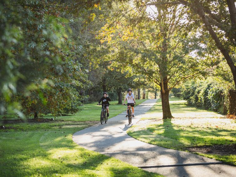 two kids riding their bikes at Picton Botanic Gardens