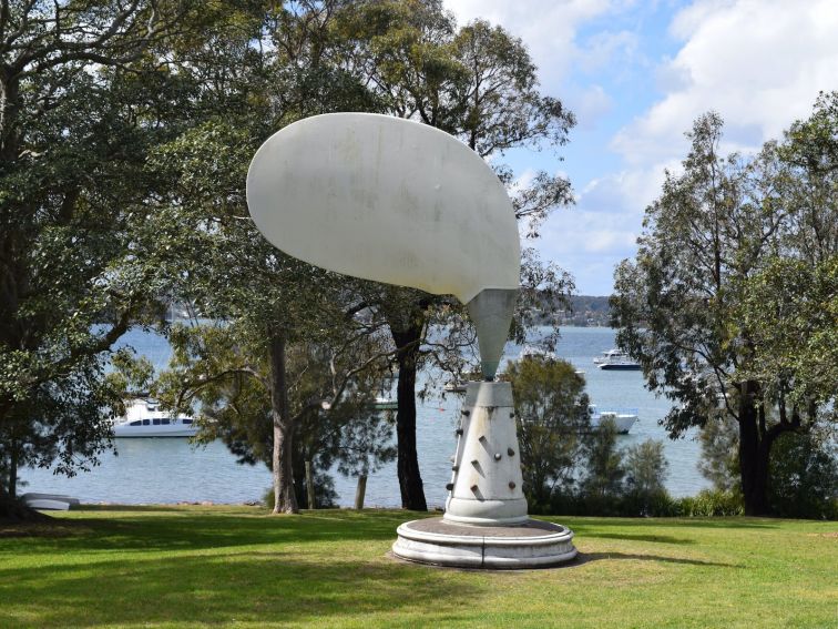 A view of John Turier's Sculpture Aeolian Tree with Lake in background