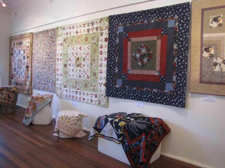 Quilts displayed on the wall