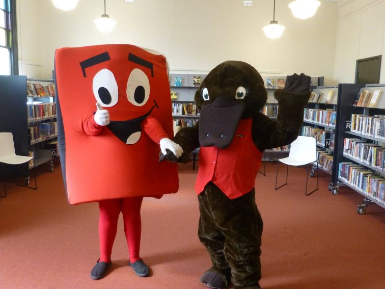 Reading mascots Book Bob, shpaed like a book and gint platypus Freed the Reader at Forbes Library