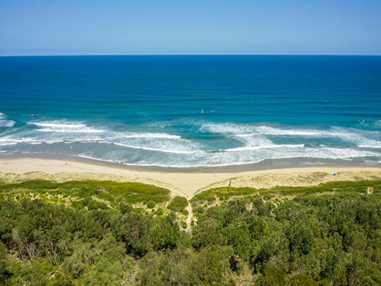 An aerial view of the path to the beach from Beach Road picnic area in Seven Mile Beach National