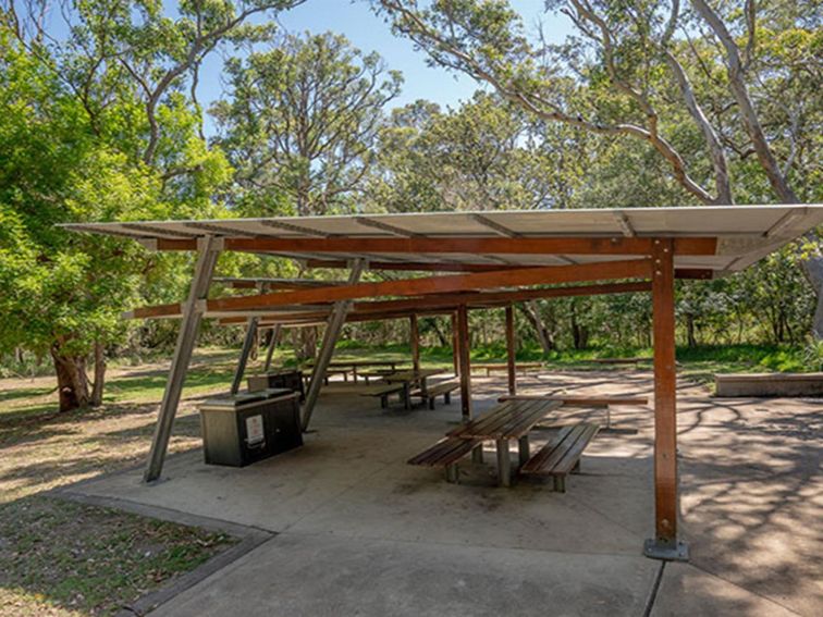 A large shelter with barbecues and picnic tables at Beach Road picnic area in Seven Mile Beach