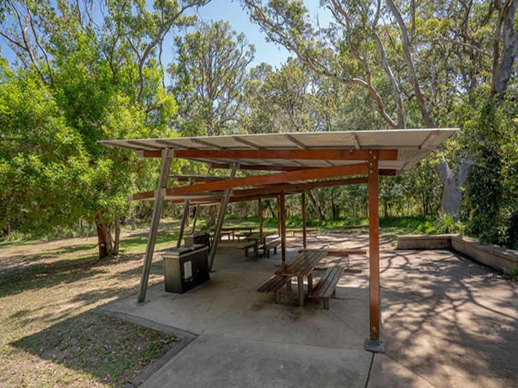A large shelter with barbecues and picnic tables at Beach Road picnic area in Seven Mile Beach