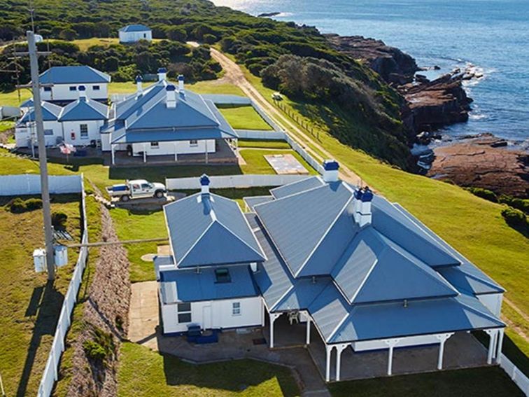 Aerial view of Green Cape Lightstation Keepers Cottages, next to the ocean. Photo: N Cubbin/DPIE