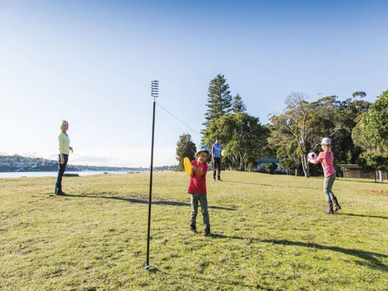 A family playing ball games on the grass at Bonnie Vale picnic area in Royal National Park. Photo: