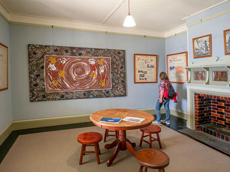 A woman viewing artwork at Cape Byron Information Centre in Cape Byron State Conservation Area.