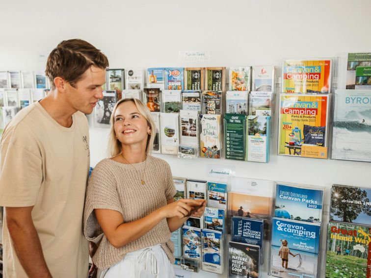 Couple looking at brochures in visitor information centre