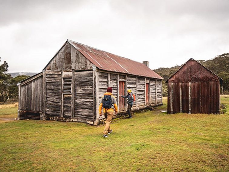 Two men outside a timber and tin building at Coolamine Homestead in Kosciuszko National Park. Photo: