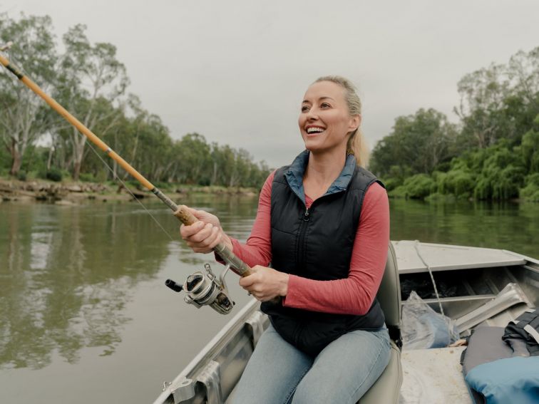 woman fishing in a boat on murray river