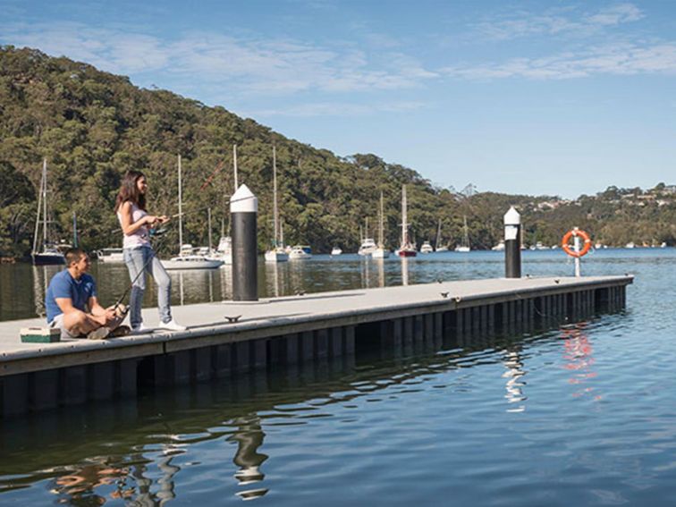 2 friends fishing on the wharf at Davidson Park picnic area in Garigal National Park. Photo: John
