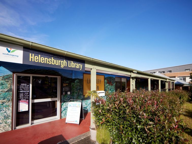 Main entrance to Helensburgh Library with bushes out the front