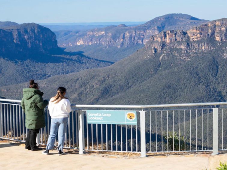 2 visitors at Govetts Leap lookout taking in the view of Grose Valley in the background. Simone
