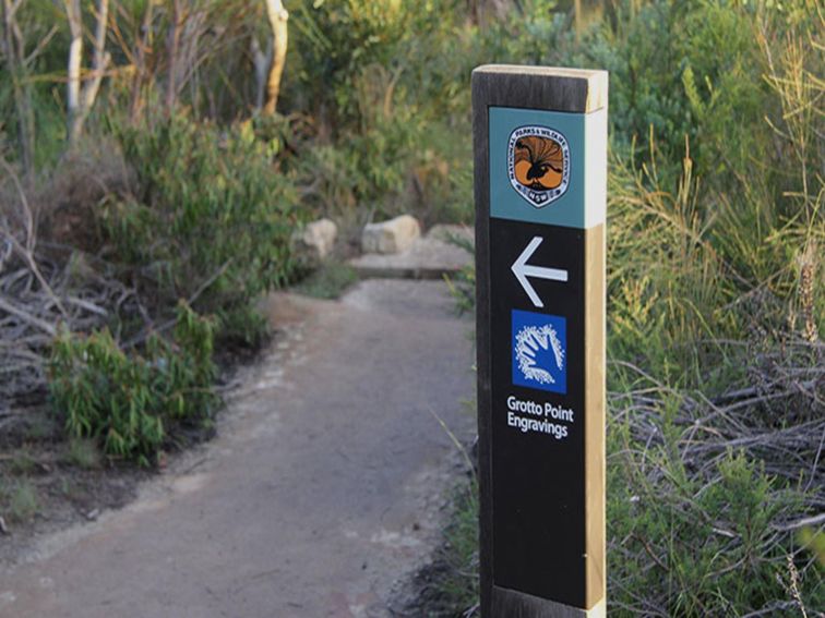Signposts point the way to Grotto Point Aboriginal engravings off Manly scenic walkway. Photo: