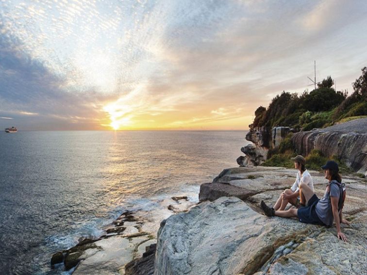 A couple enjoying the sunrise, Hornby Lighthouse at South Head, Sydney Harbour National Park. Photo: