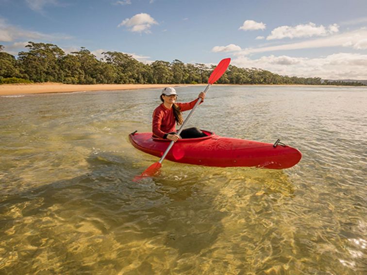 Woman in kayak at Bithry Inlet, at the mouth of Wapengo Lake in Mimosa Rocks National Park. Photo: