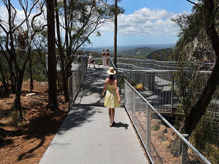 A visitor walking up to Minyon Falls lookout, in Nightcap National Park. Photo: Jimmy Malecki &copy;