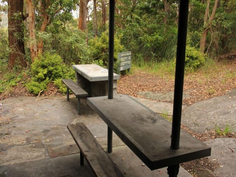 The picnic tables under a shelter at Mount Bouddi (Dingeldei) picnic area in Bouddi National Park.