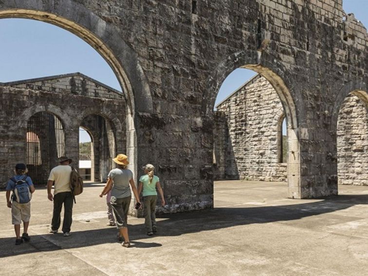 A family walking through an archway at Trial Bay Gaol in Arakoon National Park. Photo: David