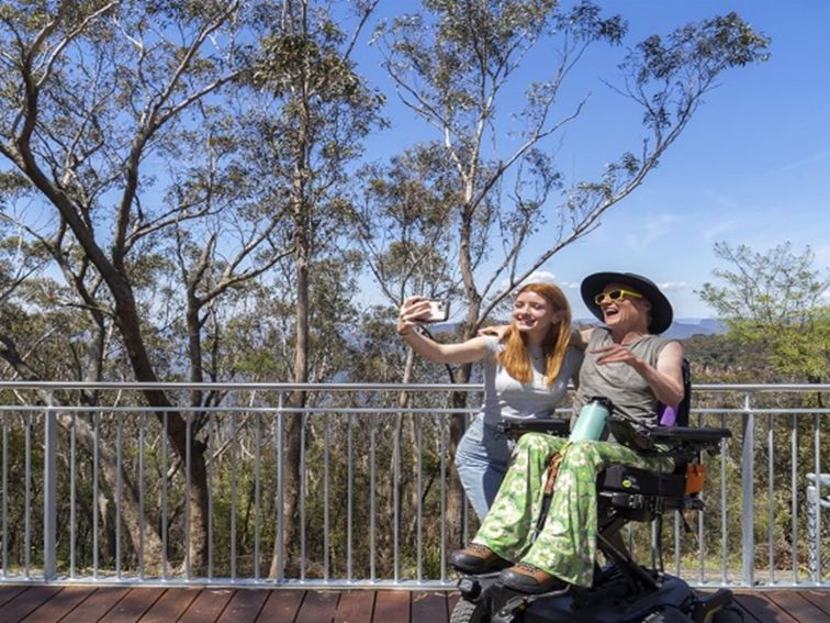 Visitors taking a photo from Valley of the Waters lookout in Blue Mountains National Park. Photo: