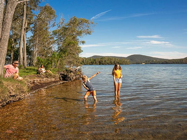 A family plays on the shore of Wallis Lake, in Booti Booti National Park. Photo credit: John Spencer