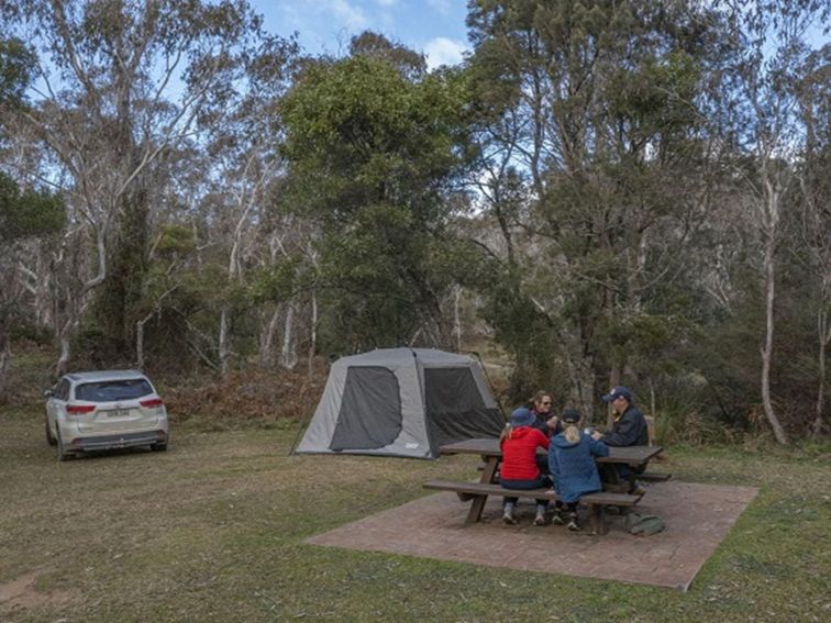 A family of campers enjoy a picnic by their tent, Werrikimbe National Park. Photo: Josh Smith &copy;