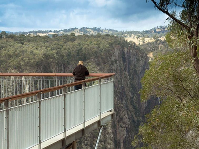 A man views Wollomombi Falls from the wheelchair-accessible lookout platform at Wollomombi Falls