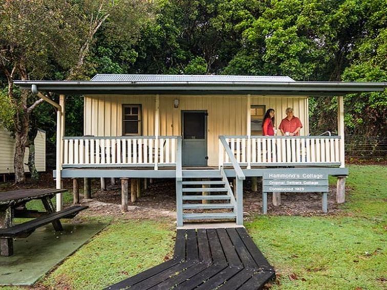 Hammonds Cottage, front exterior with visitors on the verandah, Woody Head, Bundjalung National Park