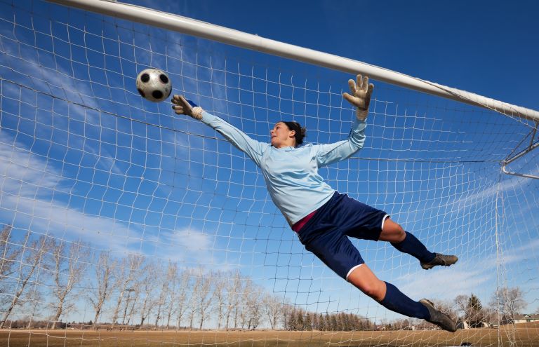 woman playing soccer in goal