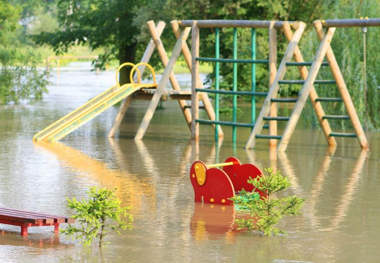 A children's playground under flood waters