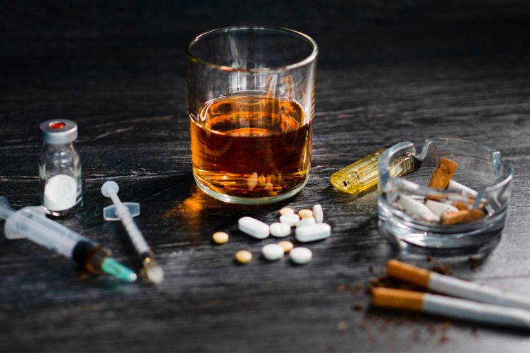 Alcohol, drugs and cigarettes on a table