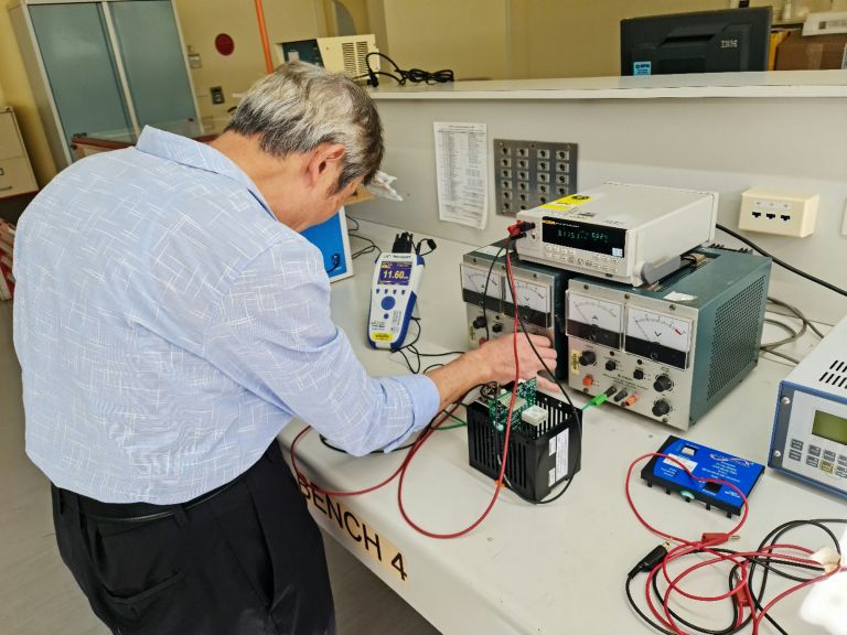 Image of man testing circuit equipment 