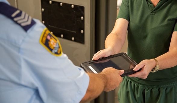 A prisoner receiving a tablet device to use