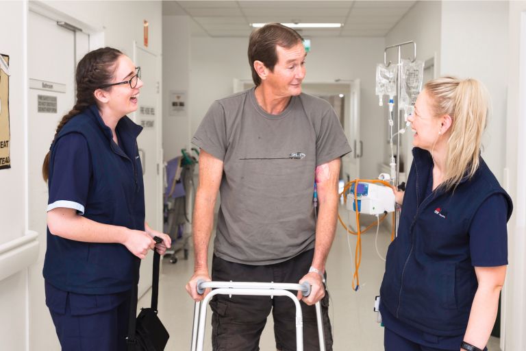 Patient walking with nurses