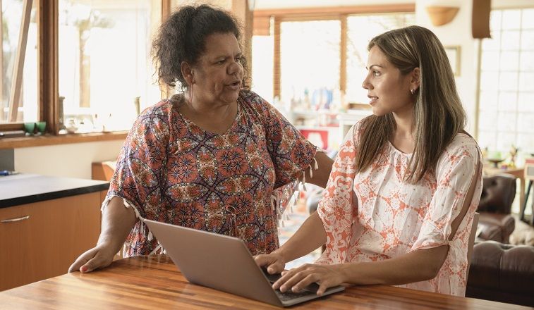 Aboriginal women talking using laptop