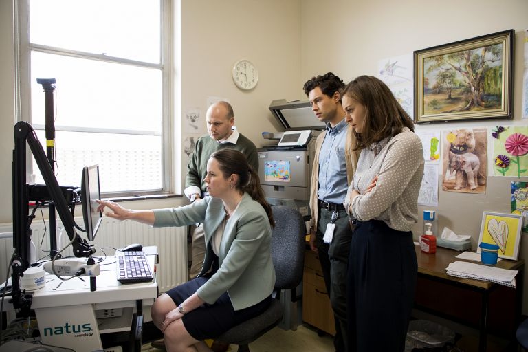 Four doctors looking at a patient's medical details