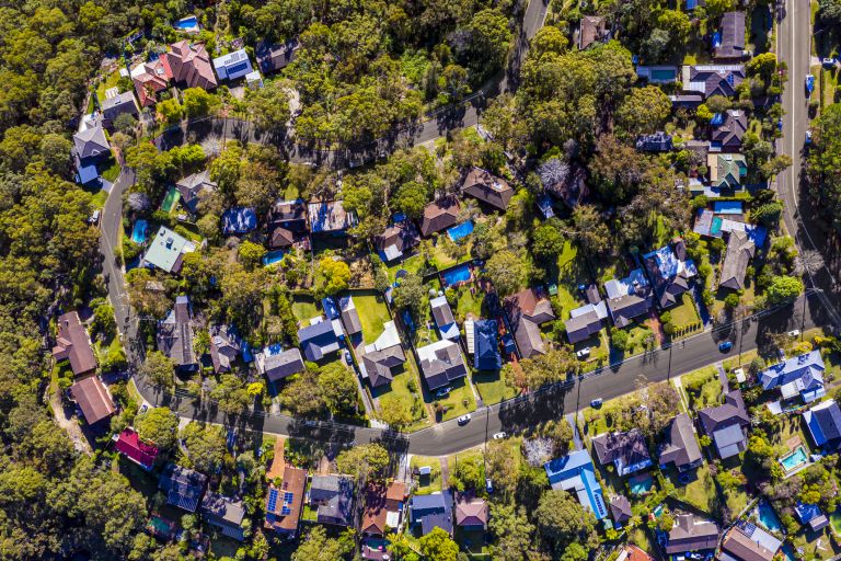 Birds eye view of bushy suburb in NSW with homes 
