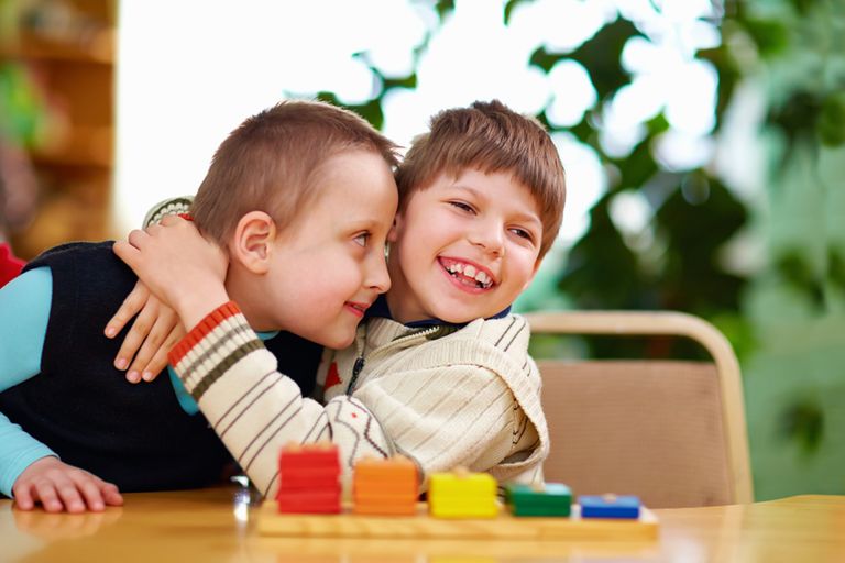 2 children at a kindergarten school tables