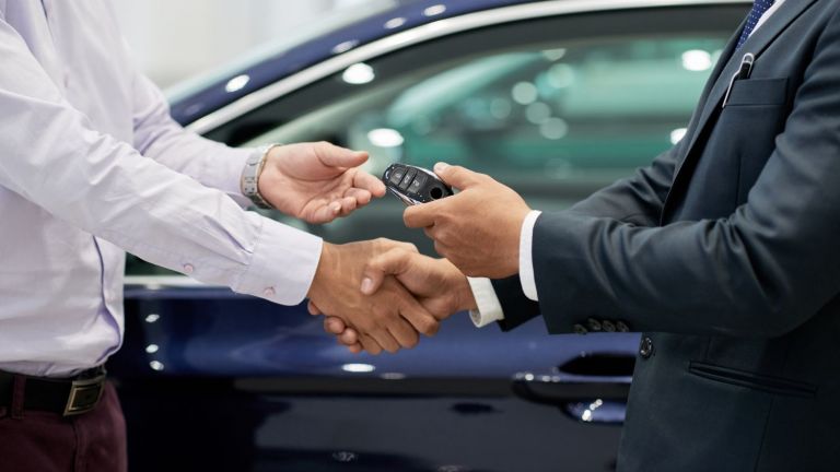 Hand shake as new car keys handed over