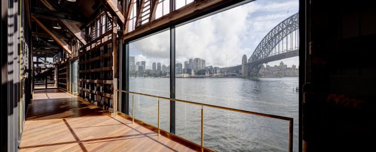 Looking out from inside a building at the Walsh Bay precinct looking at the Sydeny Harbour bridge. 