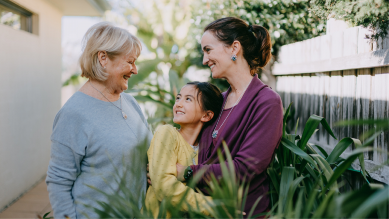 Three generations in the garden – a grandmother, daughter and granddaughter.
