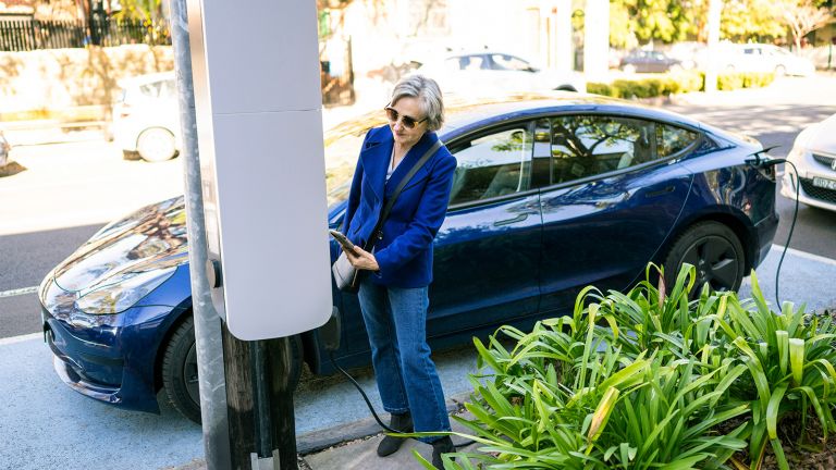 Lady charging her electric car 