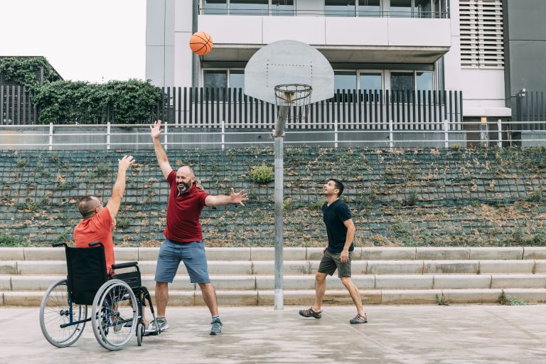 joyful disabled man wheelchair playing basketball